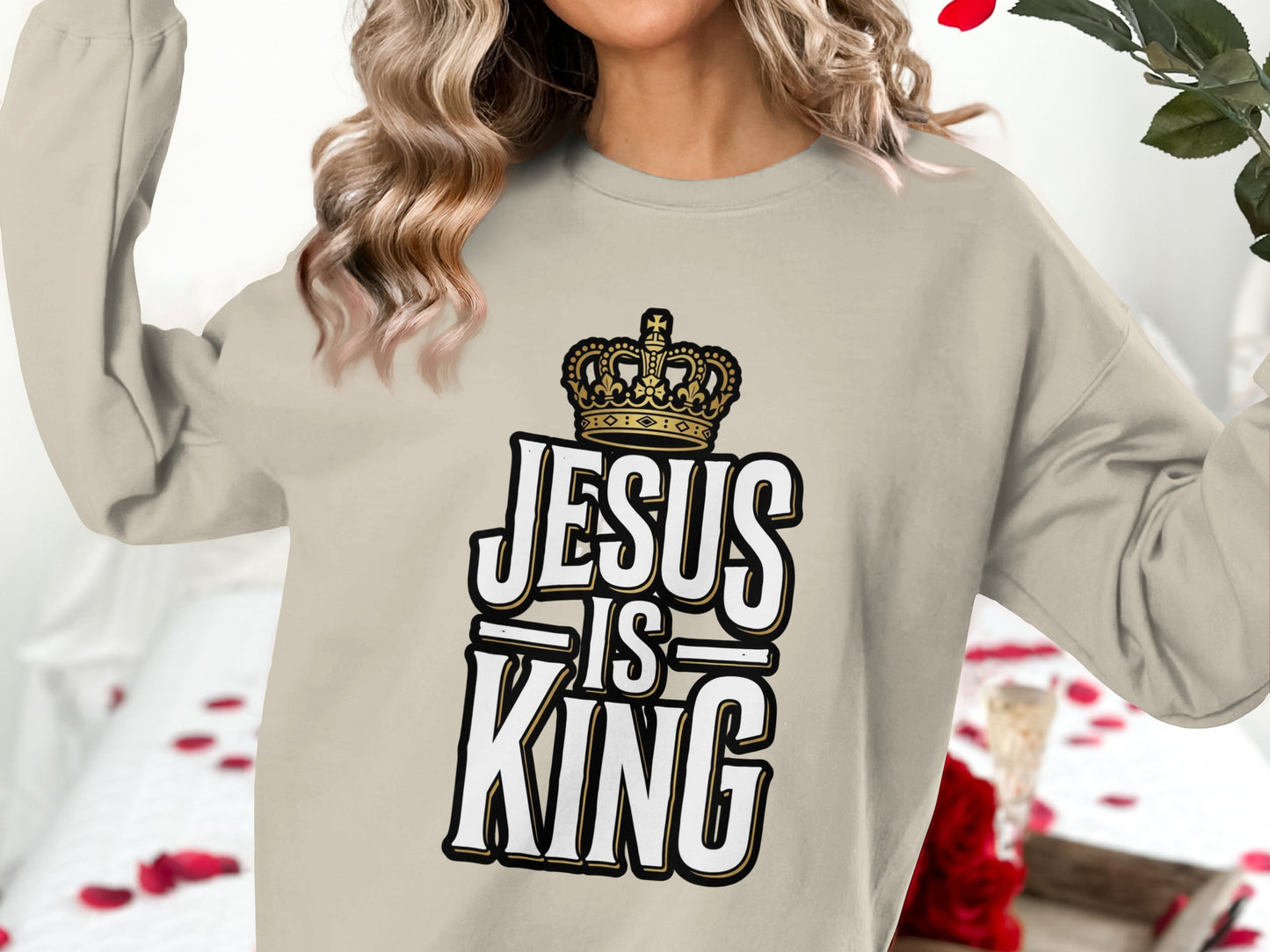 Cream sweatshirt with "Jesus is King" text and crown graphic.