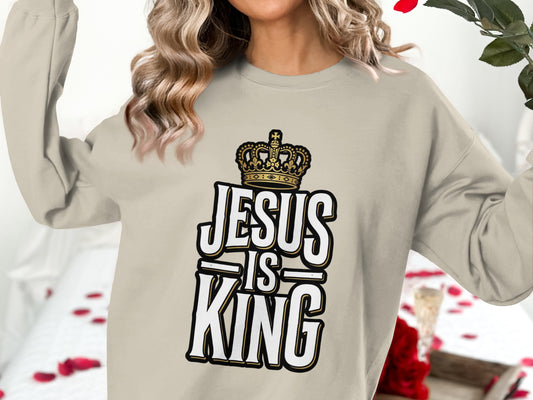 Cream sweatshirt with "Jesus is King" text and crown graphic.