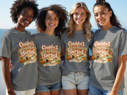 Four women wear grey t-shirts with "Couldn't Keep Him Buried JESUS WINS" graphic.