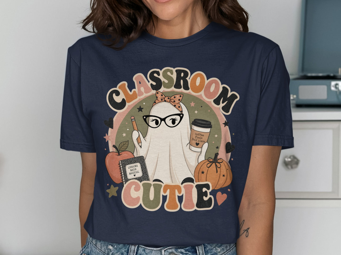 Classroom Cutie ghost wearing glasses holding a pencil and coffee cup, with an apple and pumpkin.