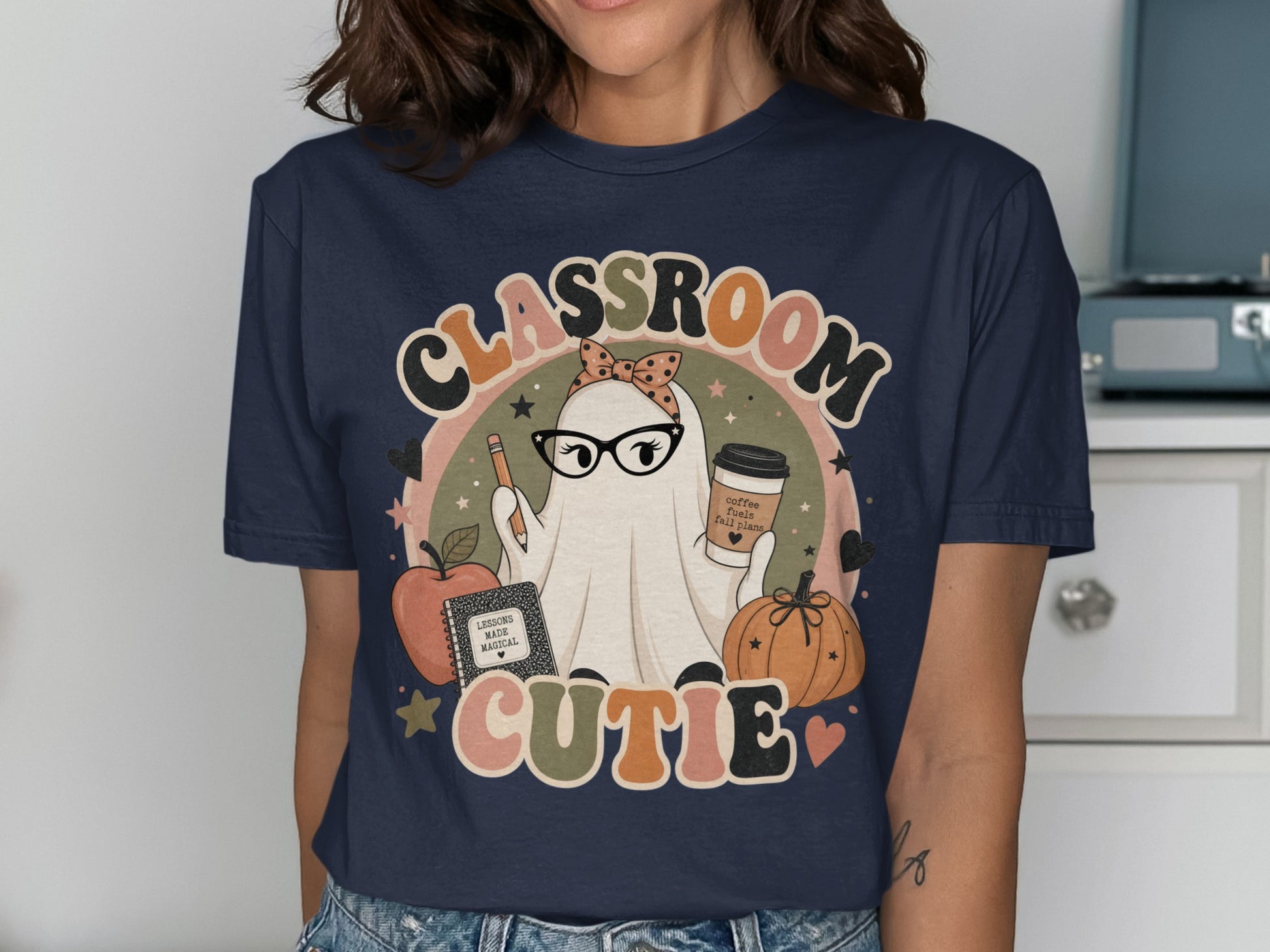 Classroom Cutie ghost wearing glasses holding a pencil and coffee cup, with an apple and pumpkin.
