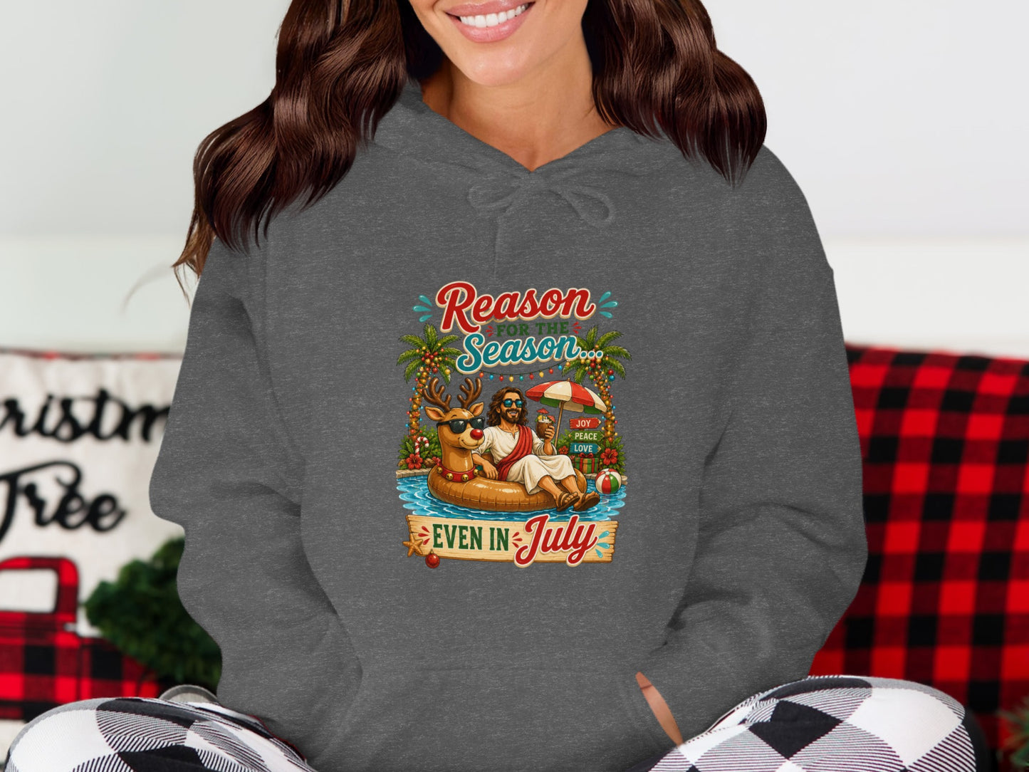 Santa and reindeer float in a pool with "Reason for the Season Even in July" text.