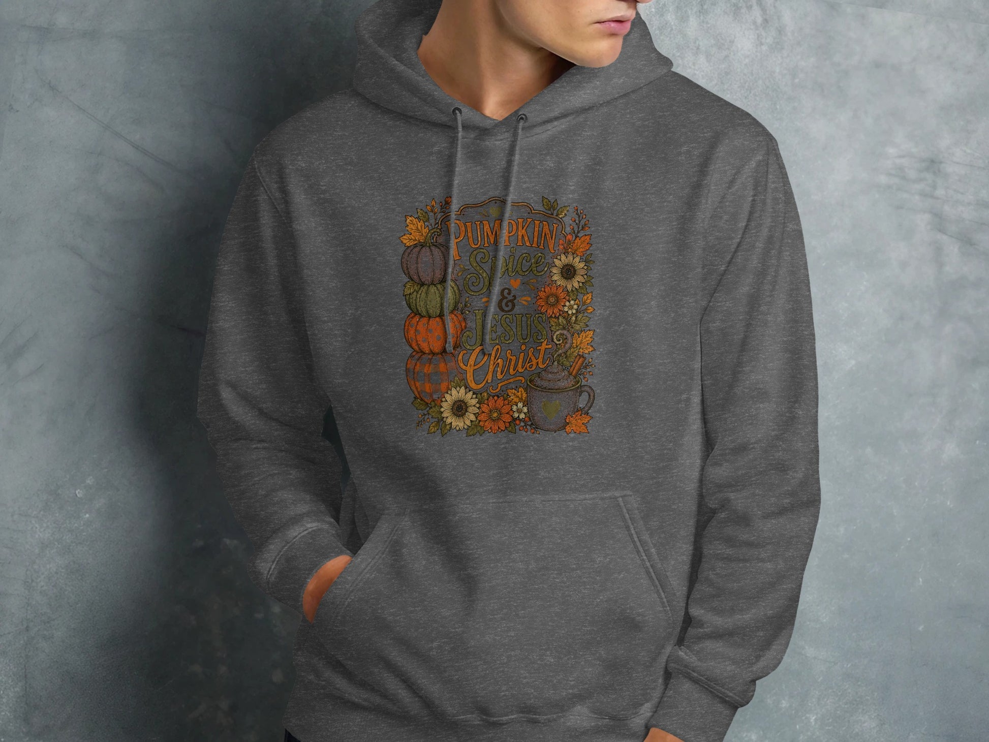 Dark grey hoodie with "Pumpkin Spice & Jesus Christ" autumn floral graphic.