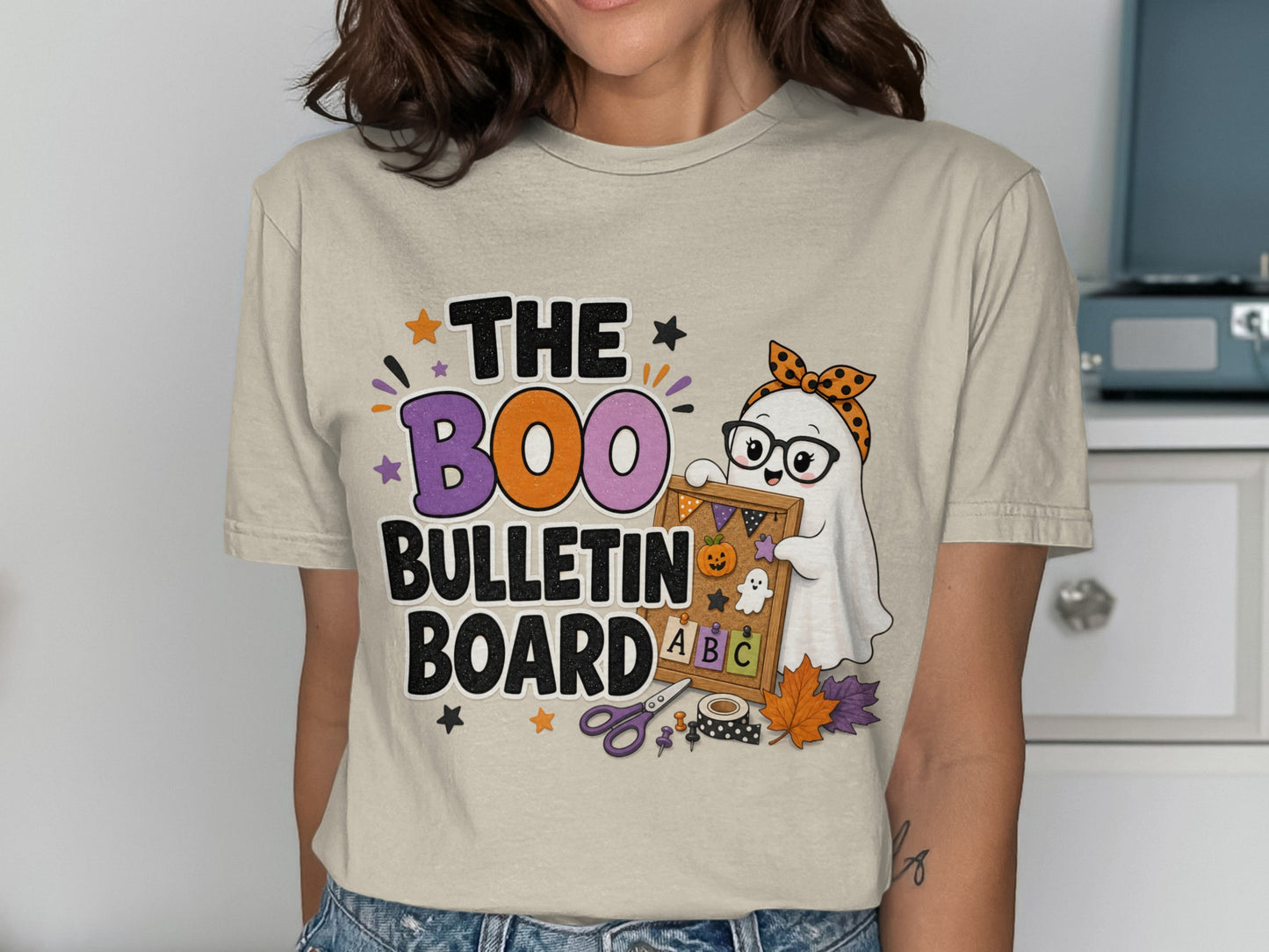 T-shirt graphic with text "The Boo Bulletin Board" and a cartoon ghost with a bulletin board.