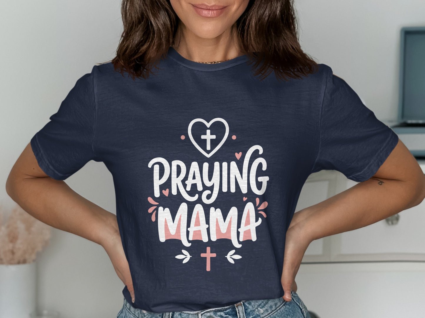 Navy t-shirt with "Praying Mama" text and heart and cross graphics.