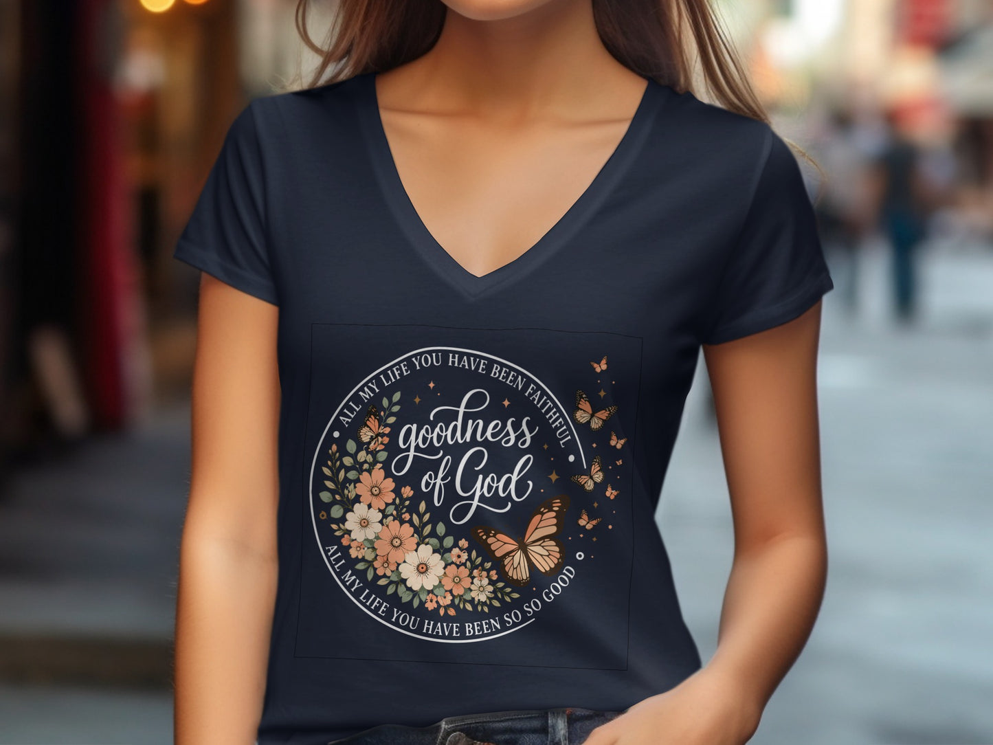 Navy v-neck t-shirt with circular floral and butterfly design and text.