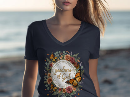 Dark t-shirt with circular floral and butterfly design: "Goodness of God".