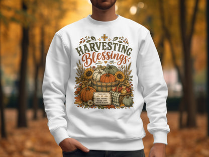 White sweatshirt with "Harvesting Blessings" and Psalm 107:1 text.