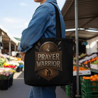 Black tote bag with "Prayer Warrior" text and shield emblem on the front.