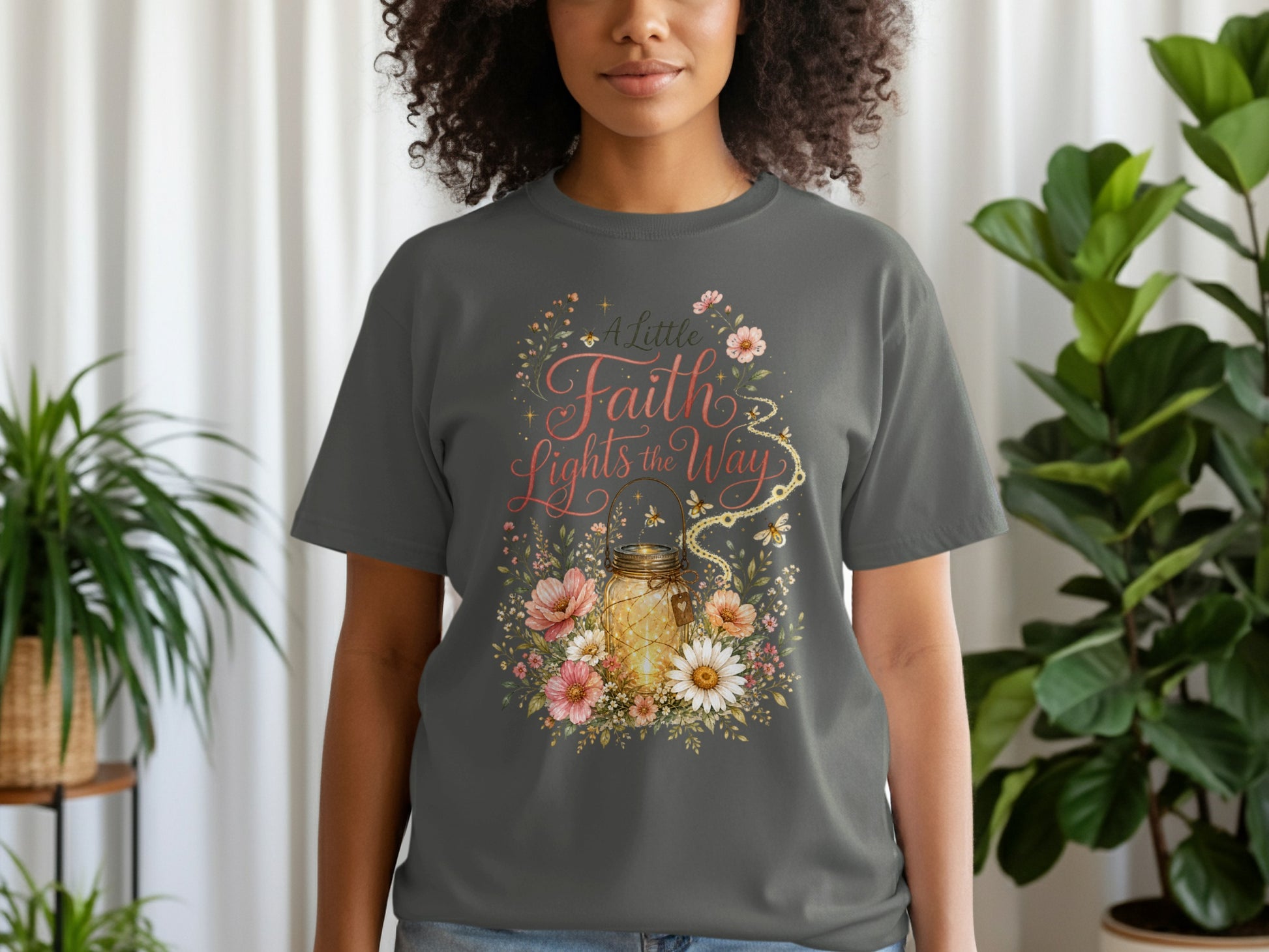 Gray t-shirt with floral design featuring a lit mason jar and text "A Little Faith Lights the Way".