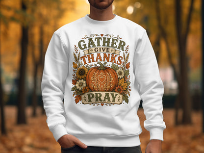 White sweatshirt with "Gather Give Thanks Pray" text and pumpkin design.
