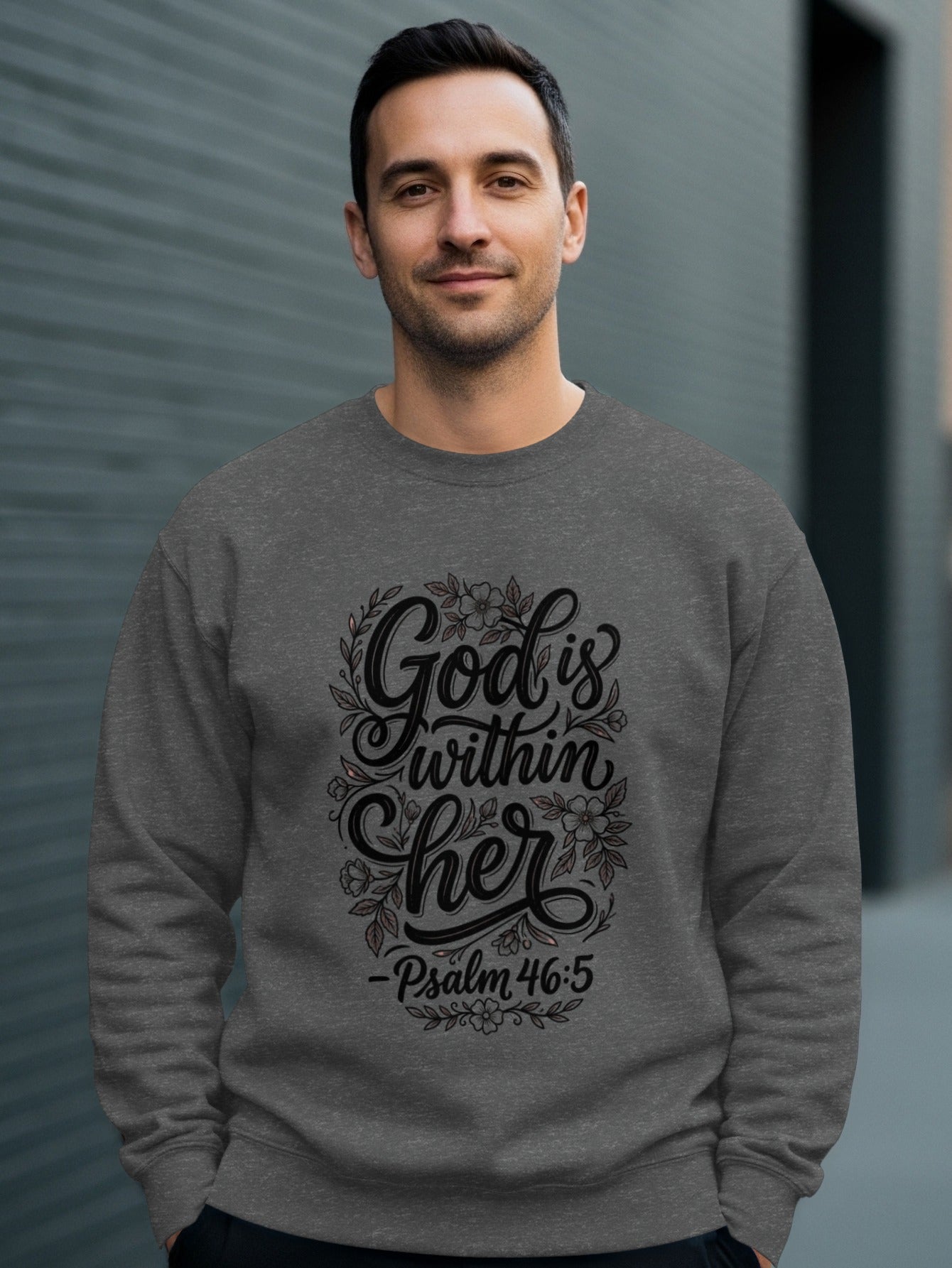 Man wearing gray sweatshirt with "God is within her Psalm 46:5" text.