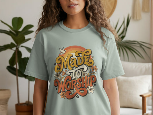 Light blue t-shirt with "Made to Worship" graphic with retro style, flowers, and dove.