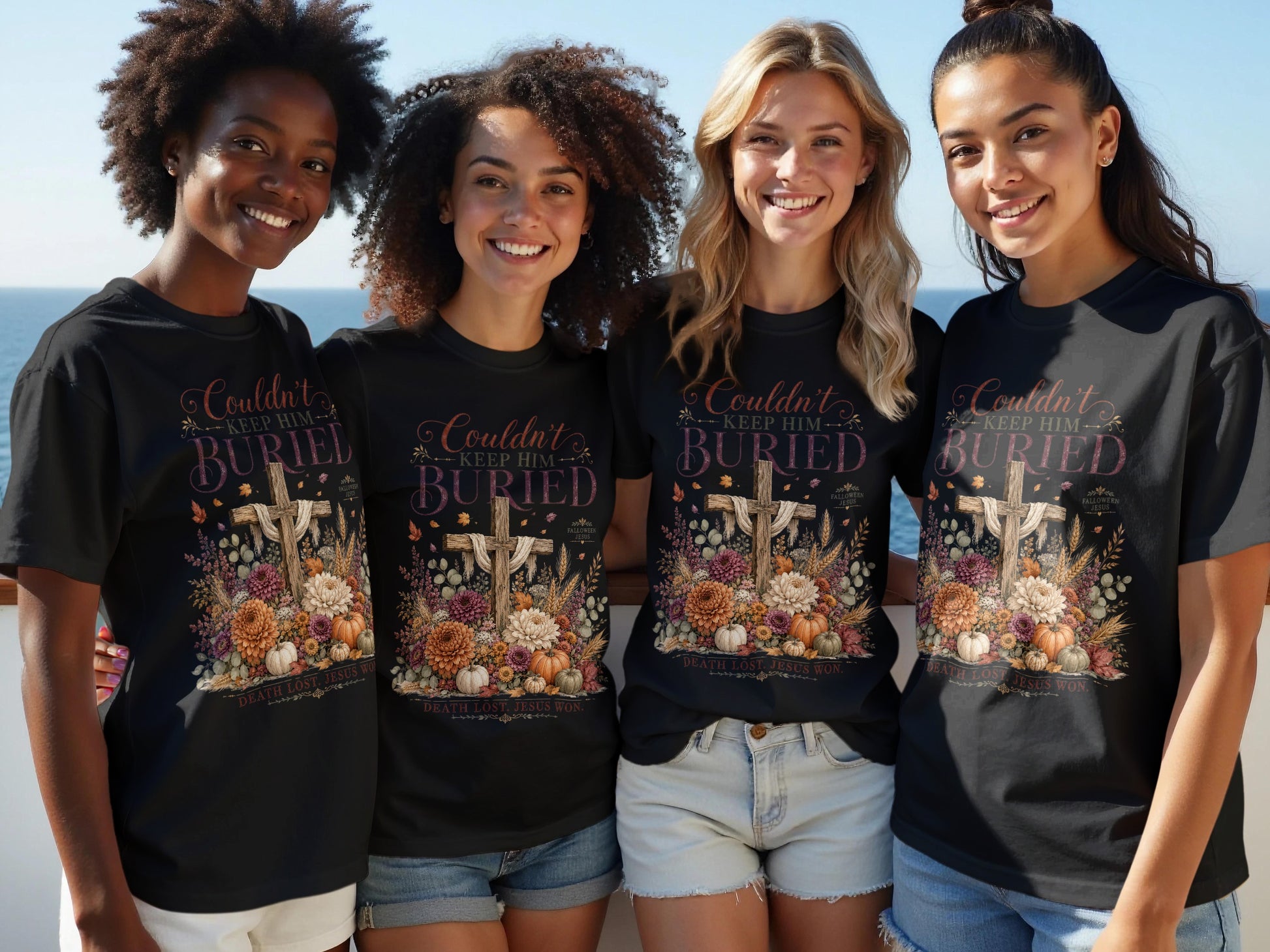 Four women model black t-shirts with a floral cross design and text reading "Couldn't Keep Him Buried."