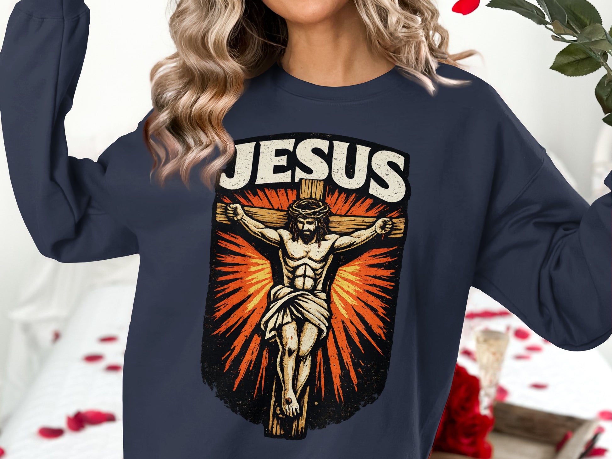 Dark navy sweatshirt with "Jesus" text above a graphic of the crucifixion.