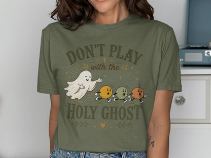 T-shirt with "Don't Play with the Holy Ghost" text and ghost with round figures.