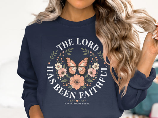 Navy sweatshirt with floral wreath and "The Lord has been faithful" text.