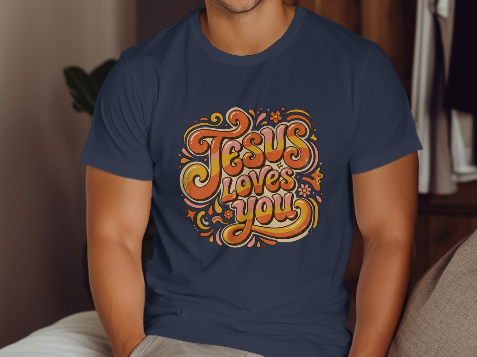 Navy t-shirt with "Jesus Loves You" in retro, colorful, groovy lettering.