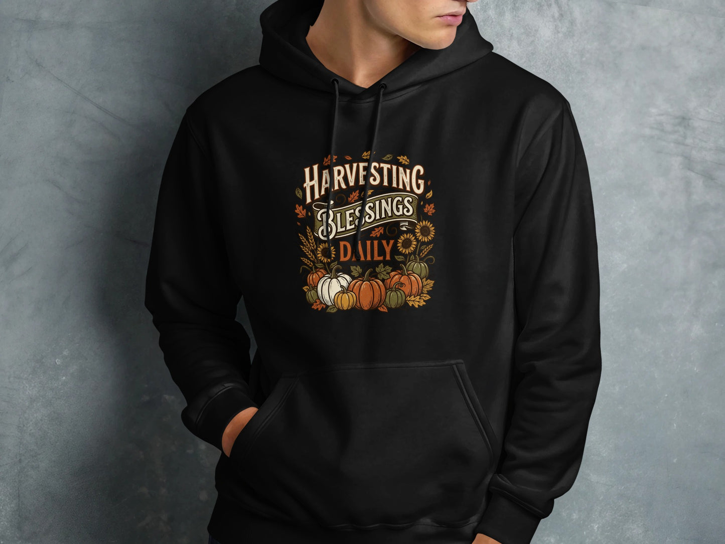 Black hoodie with "Harvesting Blessings Daily" text and fall pumpkins.