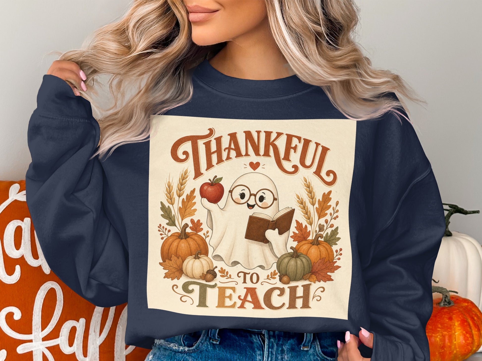 Ghost wearing glasses reading book, with text "Thankful to Teach" and autumn decorations.