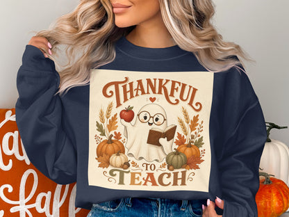 Ghost wearing glasses reading book, with text "Thankful to Teach" and autumn decorations.