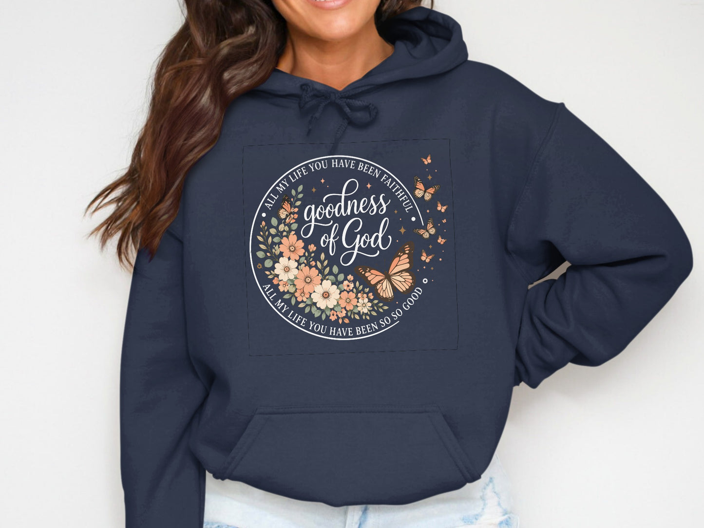 Navy hoodie with circular floral design and text "goodness of God".