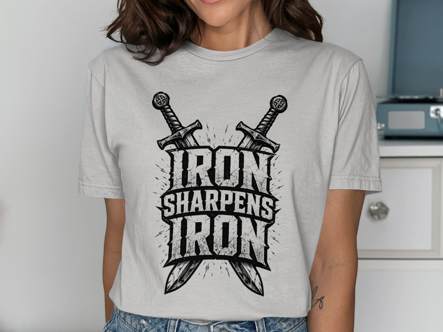 T-shirt with "Iron Sharpens Iron" text and crossed swords graphic.