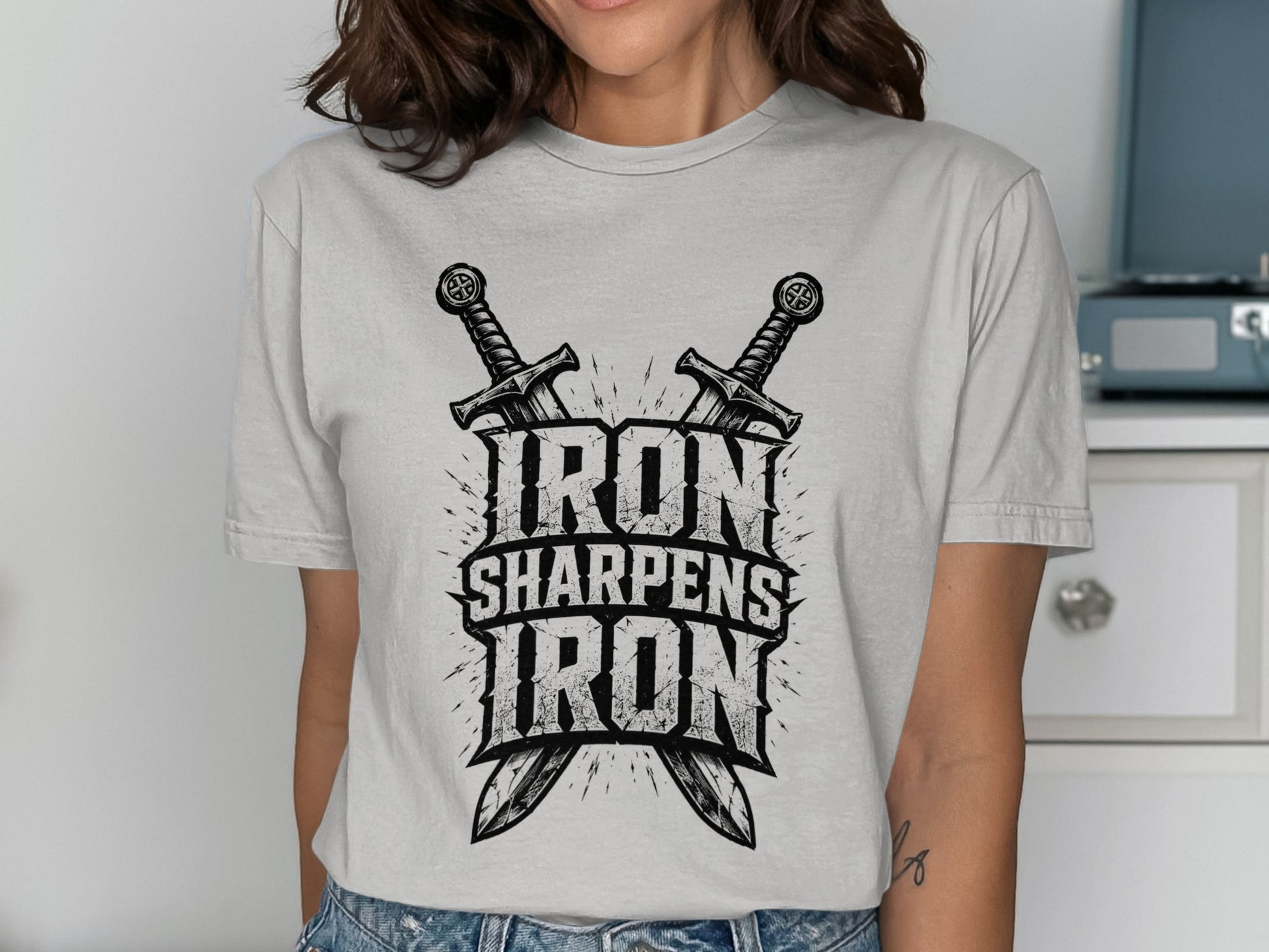T-shirt with "Iron Sharpens Iron" text and crossed swords graphic.