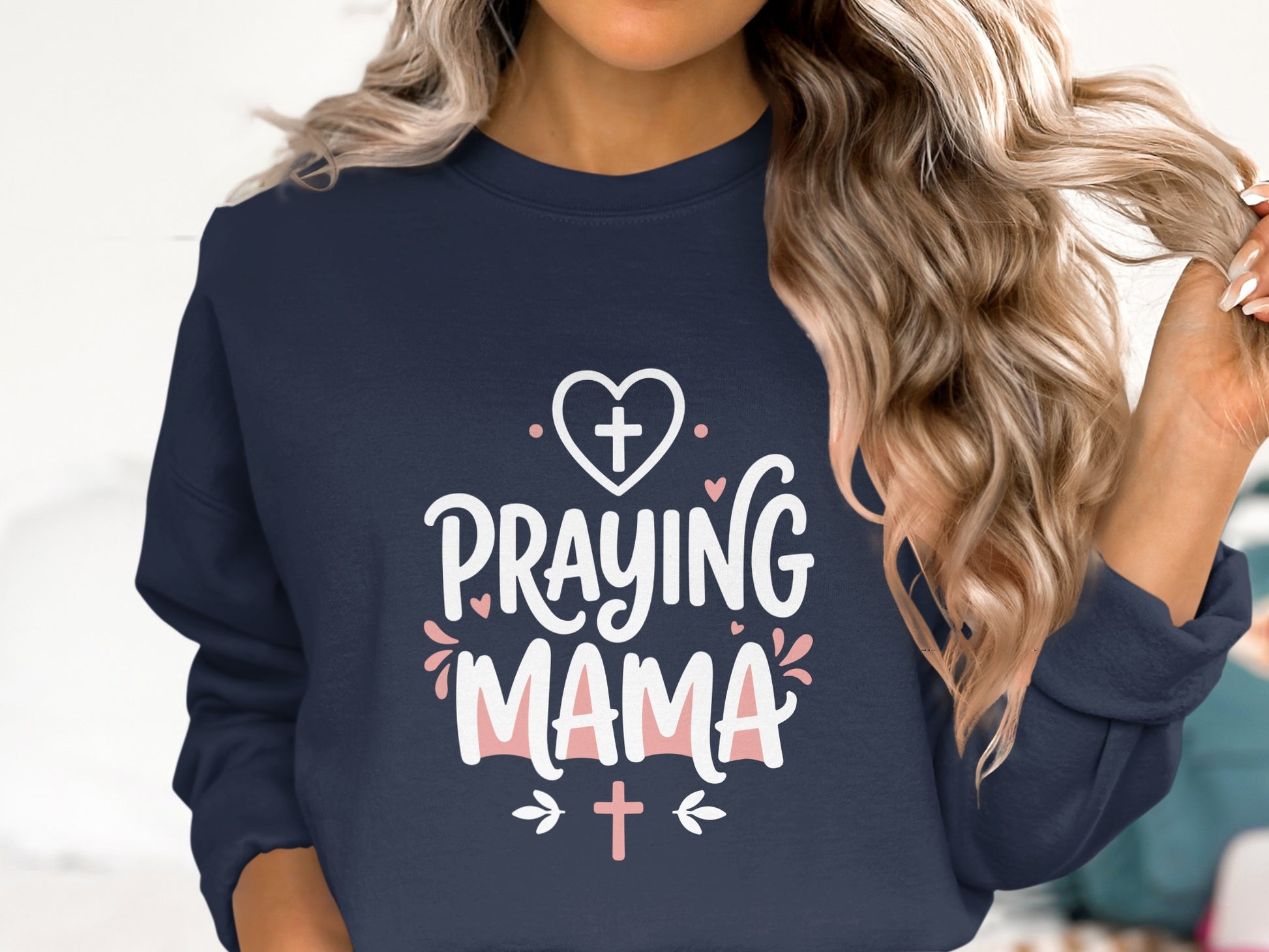 Navy sweatshirt with "Praying Mama" text and heart graphics.