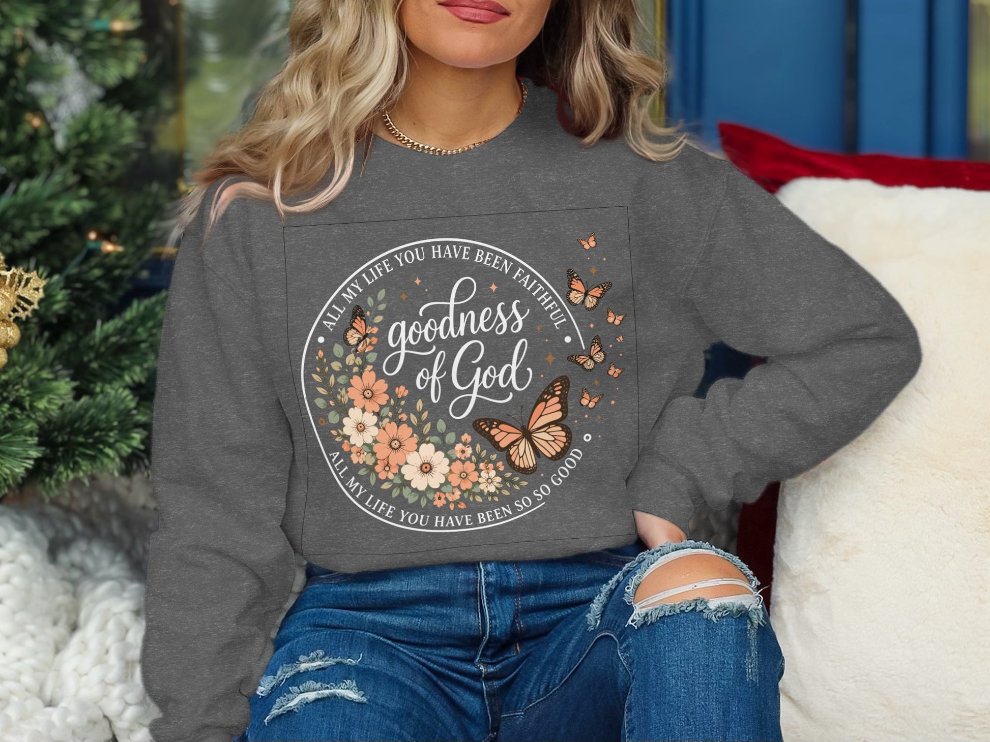 Gray sweatshirt with "Goodness of God" text and floral, butterfly design.