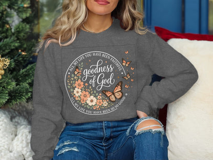 Gray sweatshirt with "Goodness of God" text and floral, butterfly design.