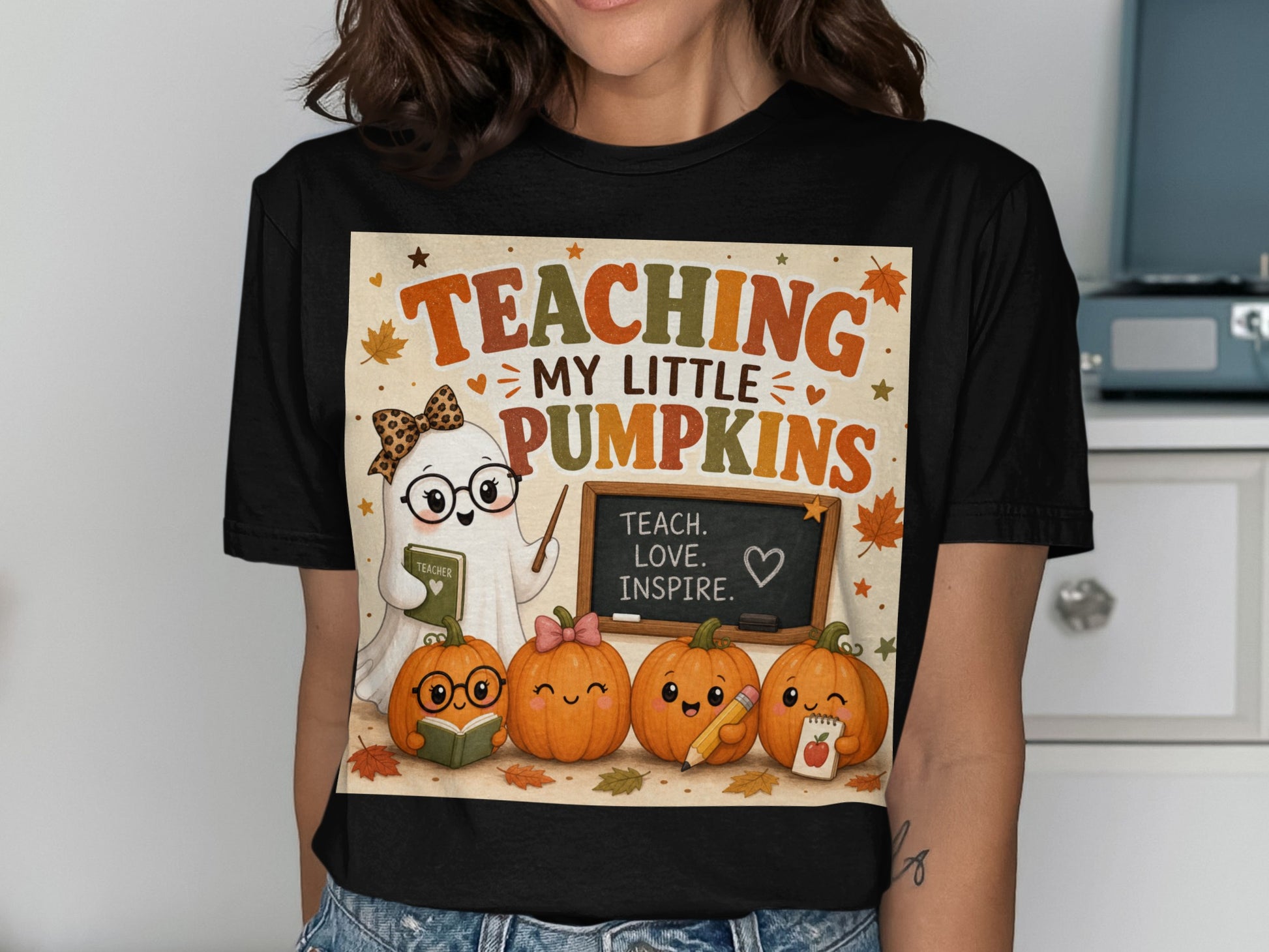 T-shirt with ghost and pumpkins design, text "Teaching My Little Pumpkins", and blackboard.