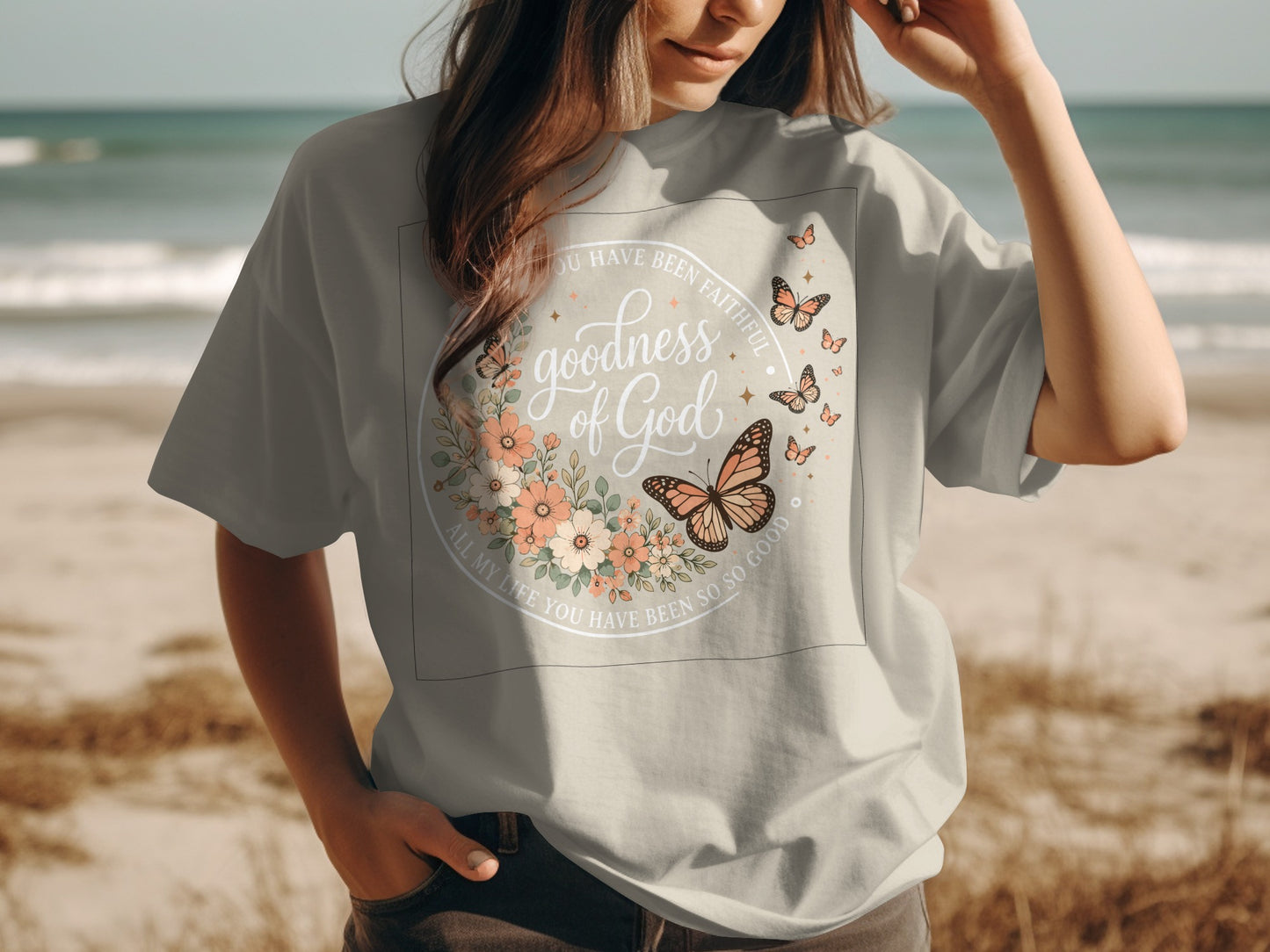 Gray t-shirt with floral wreath and butterflies; "goodness of God" text.