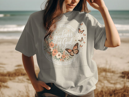 Gray t-shirt with floral wreath and butterflies; "goodness of God" text.