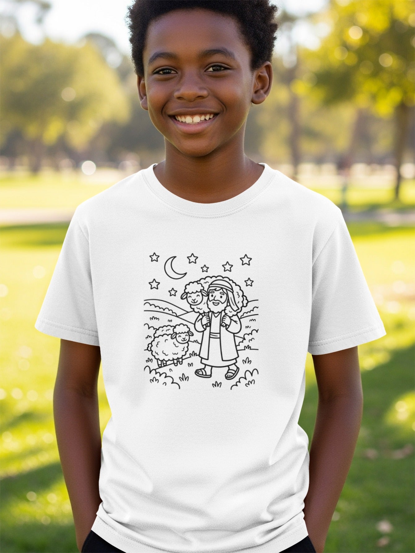 Boy wearing a white t-shirt with a drawing of Jesus holding a sheep.