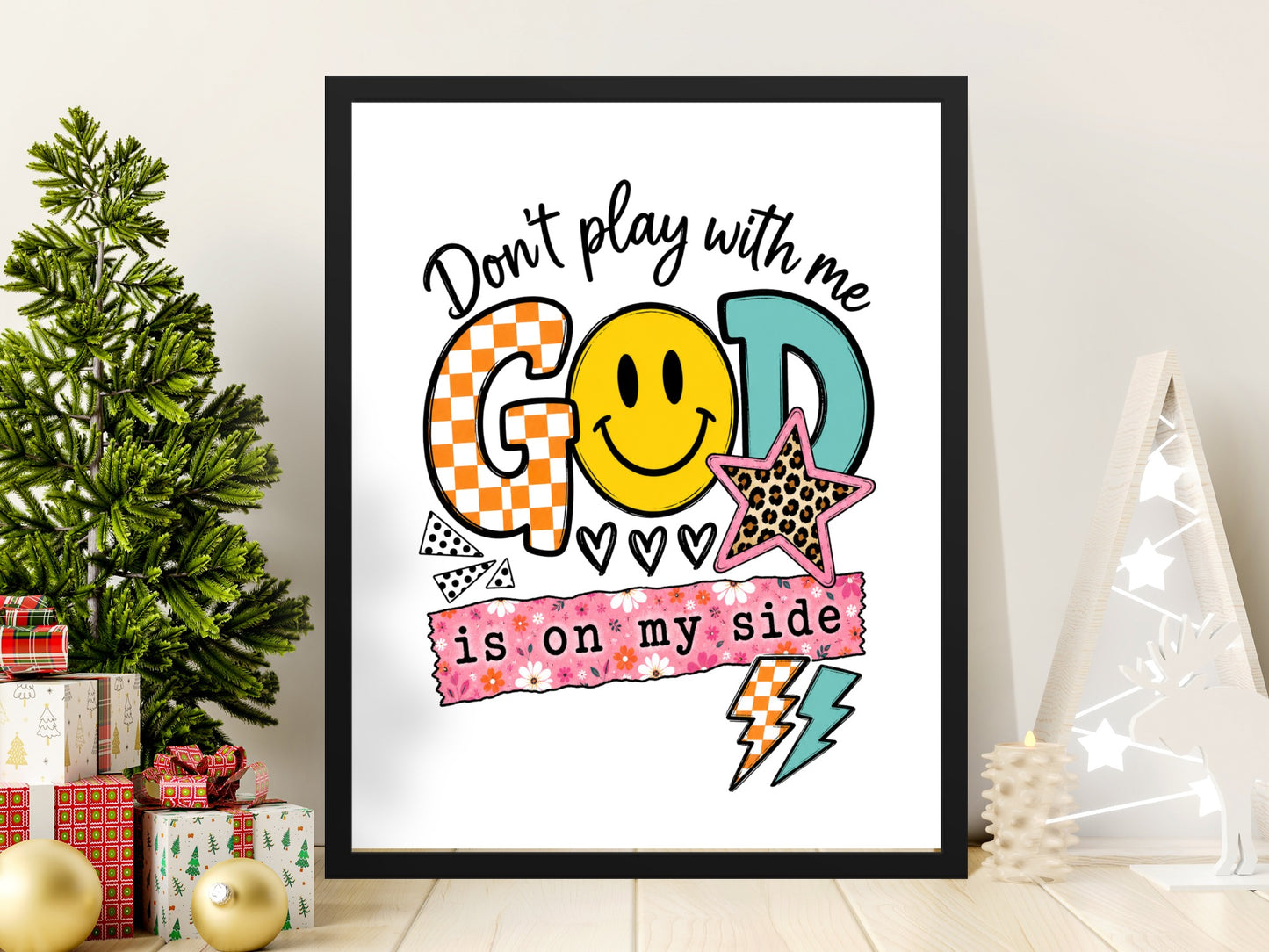 Framed art with text "Don't play with me GOD is on my side" and smiley face.