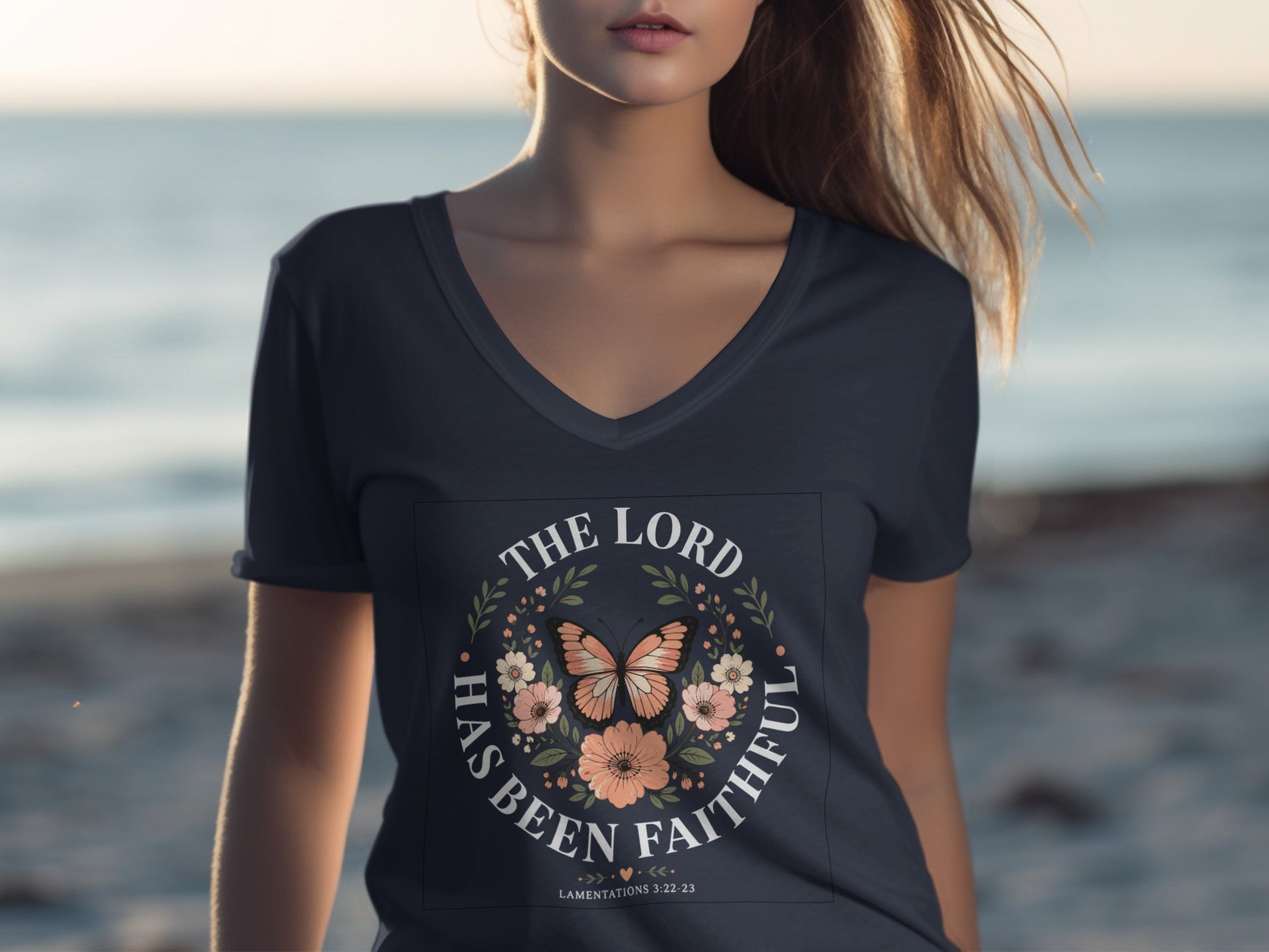 V-neck t-shirt with circular floral and butterfly design, reading "The Lord has been faithful."