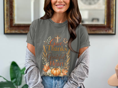 Grey t-shirt with "Give Thanks With a Grateful Heart" text, cross, pumpkin, and autumn leaves.