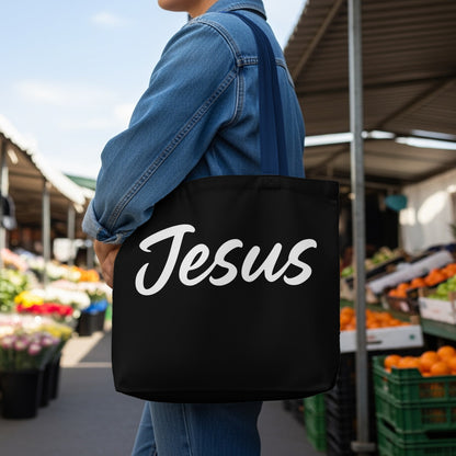 Black tote bag with "Jesus" written in white cursive script.