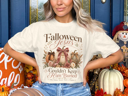 Cream t-shirt with text "Falloween Jesus Couldn't Keep Him Buried".