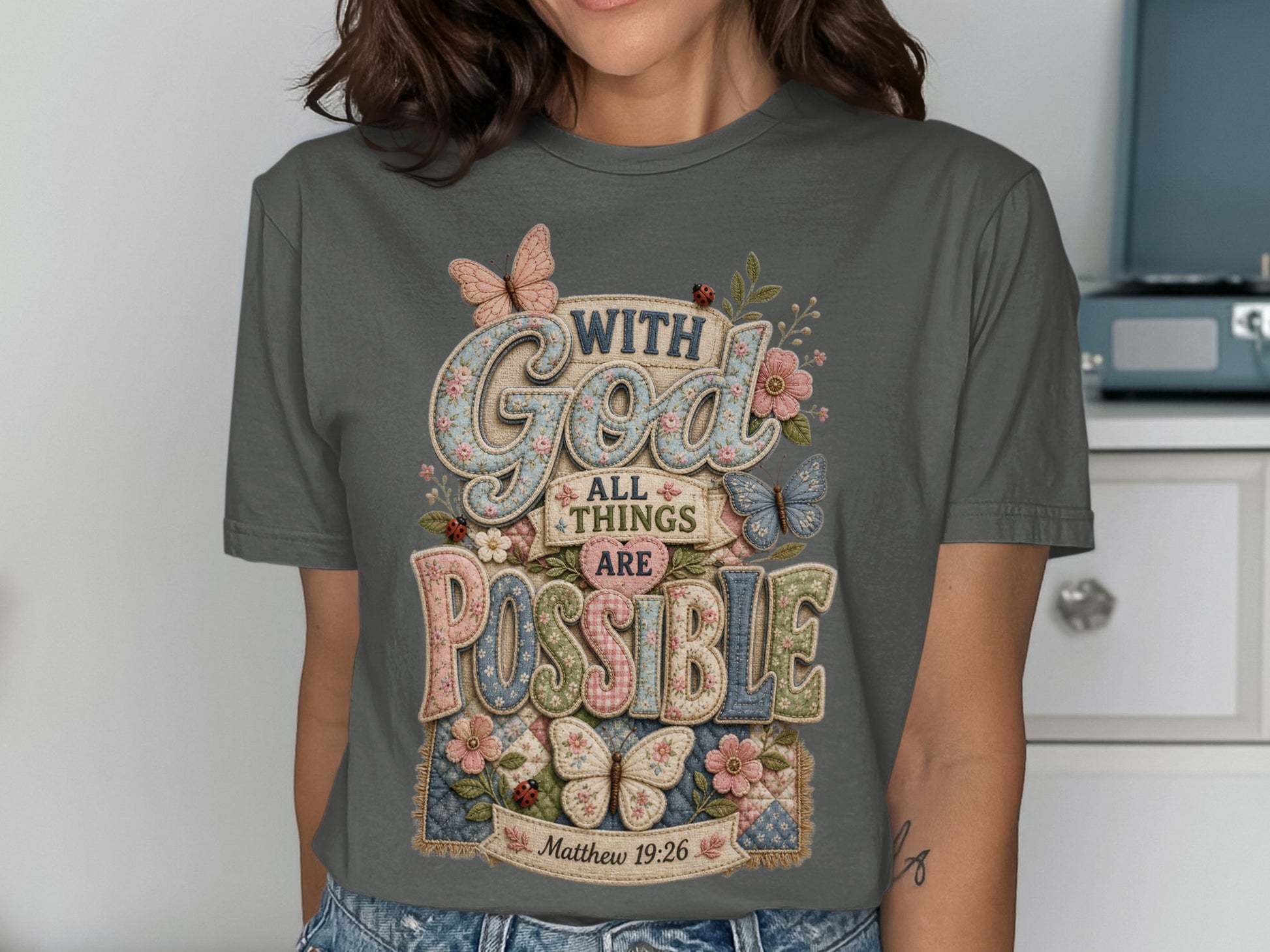 Gray t-shirt with "With God All Things Are Possible" text and floral, butterfly designs.