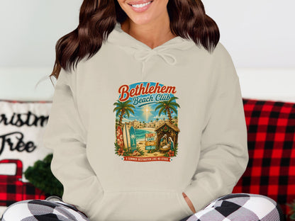 Bethlehem Beach Club hoodie with tropical Nativity scene and text.