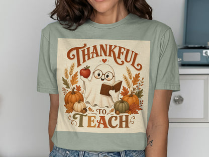 Cute ghost in glasses holding an apple and book with pumpkins and leaves, "Thankful to Teach" text.