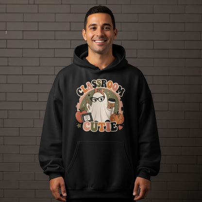 Black hoodie with "Classroom Cutie" ghost, apple, book, and pumpkin graphic.