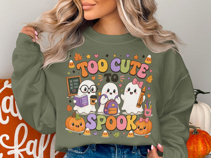 Cute ghosts and pumpkins with "Too Cute To Spook" text on a sweatshirt.
