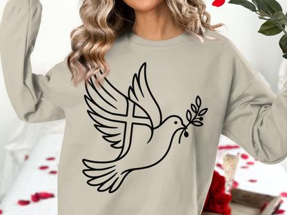 Beige sweatshirt with a black outline design of a dove holding an olive branch with a cross.