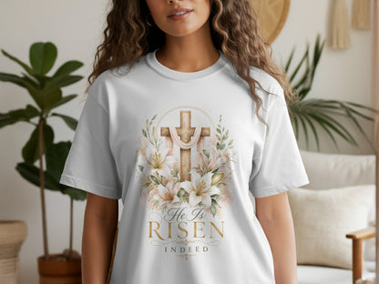 White t-shirt with a floral cross design and "He Is Risen Indeed" text.