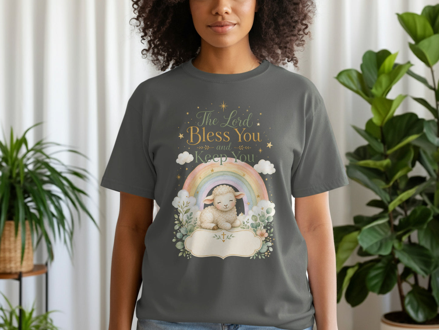 Gray t-shirt with a watercolor design of a lamb, rainbow, clouds, and text reading "The Lord Bless You and Keep You".