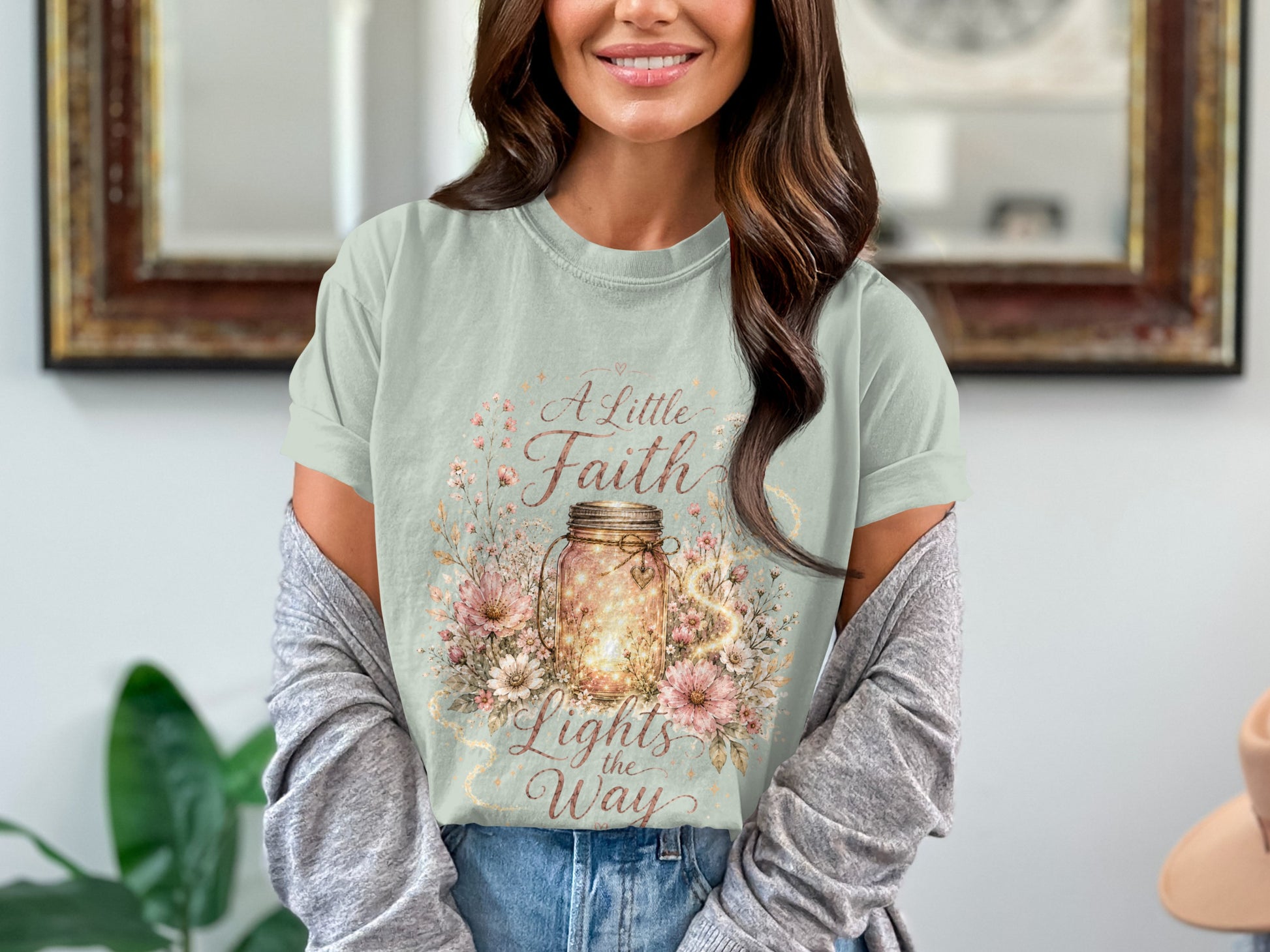 Light green t-shirt with a mason jar filled with lights, surrounded by flowers and text.
