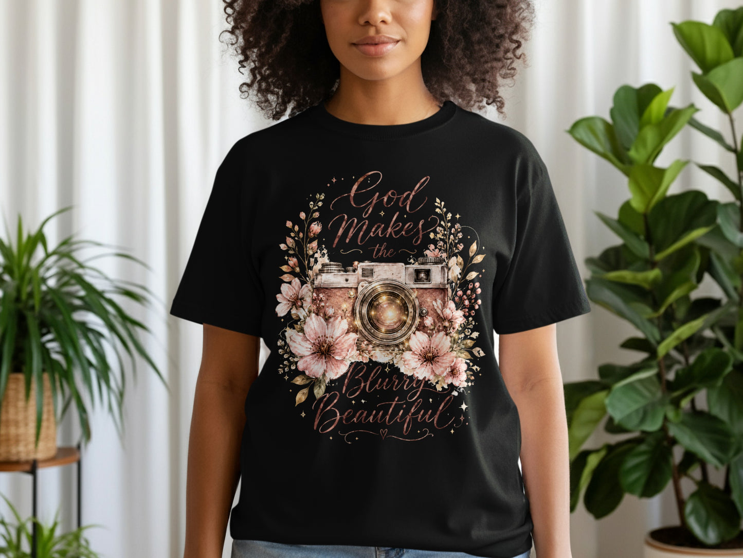 Black t-shirt with a vintage camera surrounded by flowers and text.